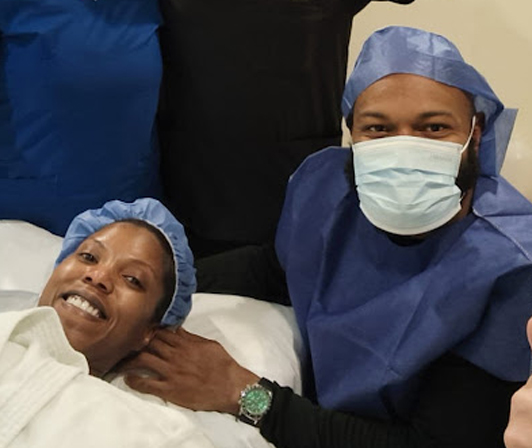 Amanda and her husband in the operating room with Dr. Castillo